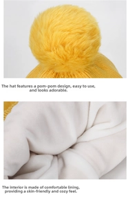 Detail of the yellow knitted hat showing the soft pompom and warm white fleece lining