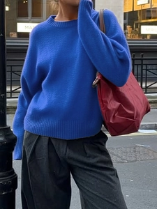 Close-up of a cozy blue round neck knitted sweater featuring soft and thick fabric texture