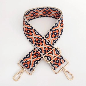 Close-up of ethnic geometric jacquard strap with light gold metal lobster clasps