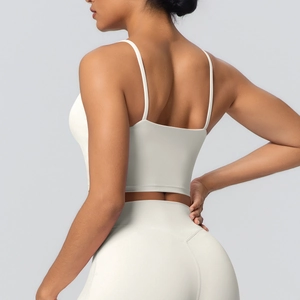 Détails d'une brassière de yoga blanche à fines bretelles et leggings de sport sans couture
