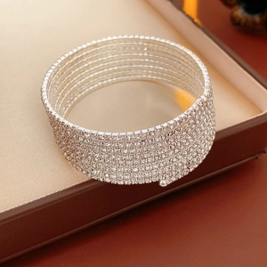 Detailed view of silver multi-layer spiral rhinestone bracelet on a jewelry gift box