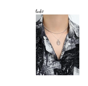 Model wearing layered silver S925 sterling silver tulip pendant necklaces on neckline