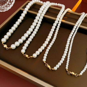 Detailed comparison of four white pearl necklaces with various bead sizes and gold magnetic clasps