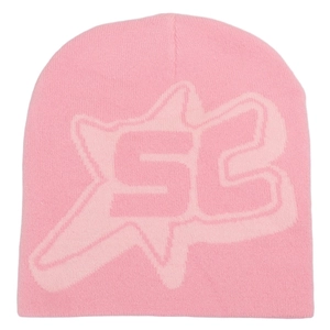Close-up of pink knitted beanie featuring textured SC letter jacquard and soft winter fabric