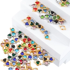 Detailed view of colorful heart-shaped crystal pendants with metal double loops for DIY jewelry