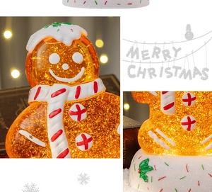 Close-up of lighted Christmas gingerbread man music box with sparkling glitter effects
