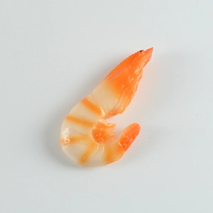 Macro detail of realistic resin cooked shrimp keychain with orange and white textures
