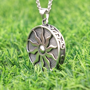 Nordic sun totem pendant in stainless steel featuring a round floral sunflower design