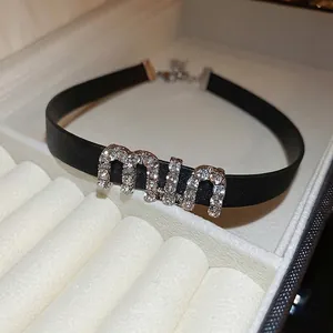 Black leather choker necklace featuring rhinestone Miu letter charms and silver buckle