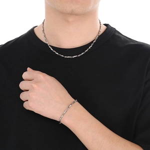Minimalist silver Chopin chain necklace and bracelet set shown on model on white background