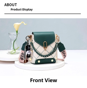 Detail of color-block bucket bag featuring green quilting and gold hexagonal rivets