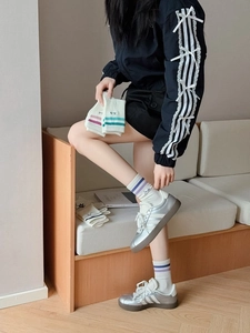 Detailed knit texture of breathable athletic crew socks with colorful stripes and Smile text