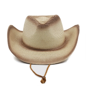 Detail of woven straw cowboy hat with brown gradient texture and adjustable chin strap