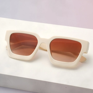 Detail view of stylish cream-white thick frame sunglasses with brown gradient lenses