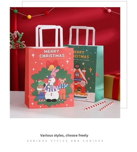 Close-up of red and green Christmas gift bags with snowman and house illustrations