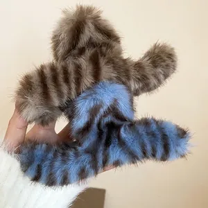 Furry oversized hair claw clip featuring stylish brown and blue tiger stripes