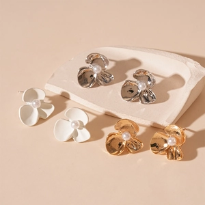 Three-petal metal flower stud earrings with pearl centers in gold, silver, and white