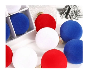 Close-up of 8cm red, blue, and white flocked Christmas ball ornaments with velvet texture