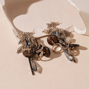 Macro detail of bohemian vintage earrings with brown wood discs and grey glass beads