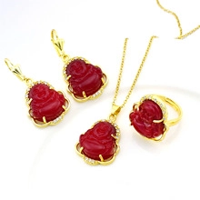 Detailed view of gold plated Maitreya Buddha pendant set with red stones and zircon accents