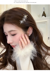 Detailed shot of three interconnected rhinestone stars on a silver French duckbill hair clip