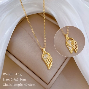 Detail view of gold wing pendant necklace with sparkling rhinestones and size parameters