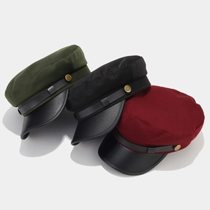 Vintage navy flat top caps in army green, black, and burgundy with leather accents