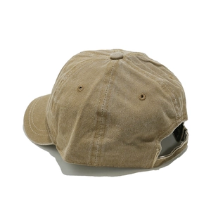 Detail of khaki cotton baseball cap showing breathable eyelets and adjustable back strap
