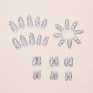 Close-up of grey and silver press on nails featuring 3D metallic wavy lines and textures