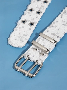Detail of white star eyelet belt with silver sequins and a shiny metal buckle