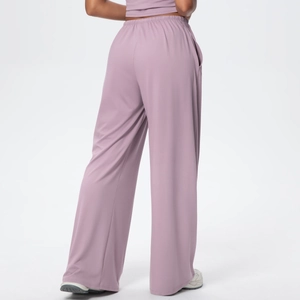 Detail view of dusty rose wide leg pants showing the soft draped fabric and side pocket
