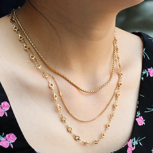 Close-up of three-layer 18K gold plated heart necklace worn on female model neck