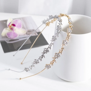 Detailed macro view of gold and silver floral headbands with sparkling rhinestones