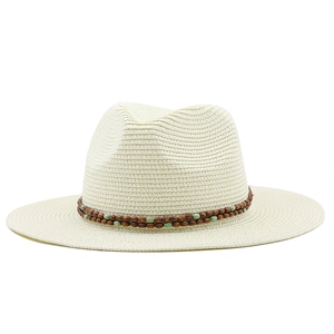 Detail of woven straw sun hat featuring double-row brown wooden bead decorative band