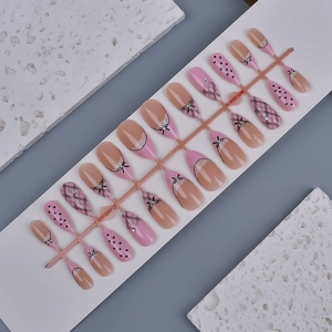 French almond press-on nails with pink bow, lace patterns, and glitter rhinestones