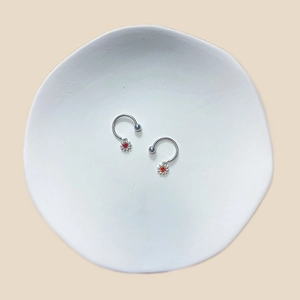 U-shaped stainless steel nipple rings with flower pendant and red gemstone