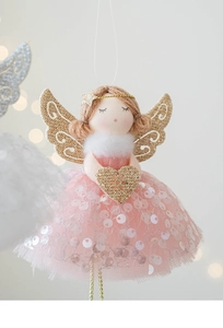 Detail of pink Christmas angel ornament with mesh wings and sparkly heart detail