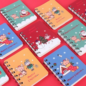 Christmas stationery gift set featuring colorful spiral notebooks with festive cartoon icons