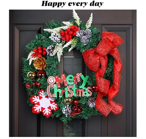 Detailed view of pine needles with red sequin bow and Merry Christmas sign on wreath