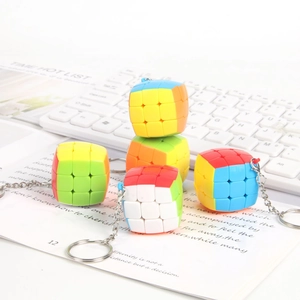 Detailed close-up of 3x3x3 colorful mini cube keychains on a decorative book page