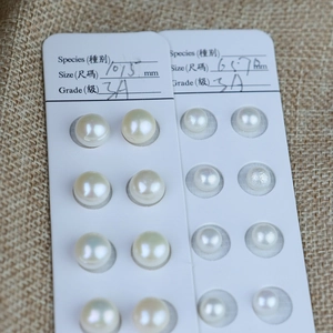 Macro detail of 3A grade natural freshwater white pearls in 10.5mm and 6.7mm sizes