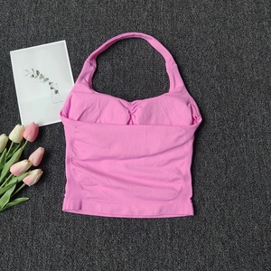 Detail of pink halter sports vest featuring ribbed hem and pleated chest design