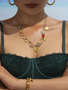 Detail of 18k gold plated necklace and earrings with colorful enamel heart pendants