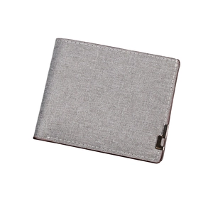 Short bifold denim wallet in grey fabric with dark brown trim, minimalist style