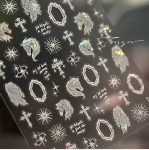 Holographic silver nail stickers with unicorn and baroque frame designs in detail
