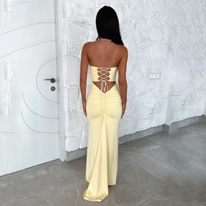 Detailed back view of yellow strapless maxi dress with lace-up tie and ruched detailing