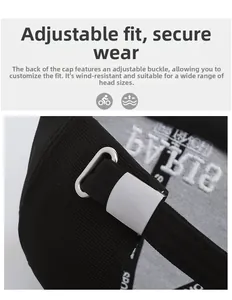 Detail of black baseball cap showing the adjustable silver metal buckle and twill fabric