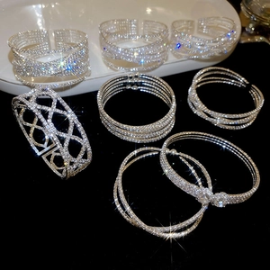 Detailed view of silver criss-cross bangle bracelets with sparkling cubic zirconia on velvet