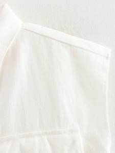 Detailed close-up of white twill cotton vest showing premium stitching and fabric texture