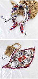 Detail of multi-color pleated silk scarf with equestrian print and zig-zag edges